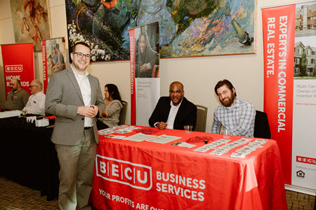 Three BECU employees at business services booth 