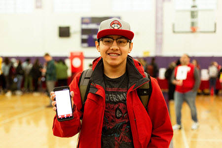 Student displaying mobile app